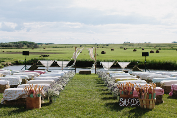 Outdoor ceremony seating with luscious green fields - wedding photo by Michigan-based wedding photographers Bryan and Mae